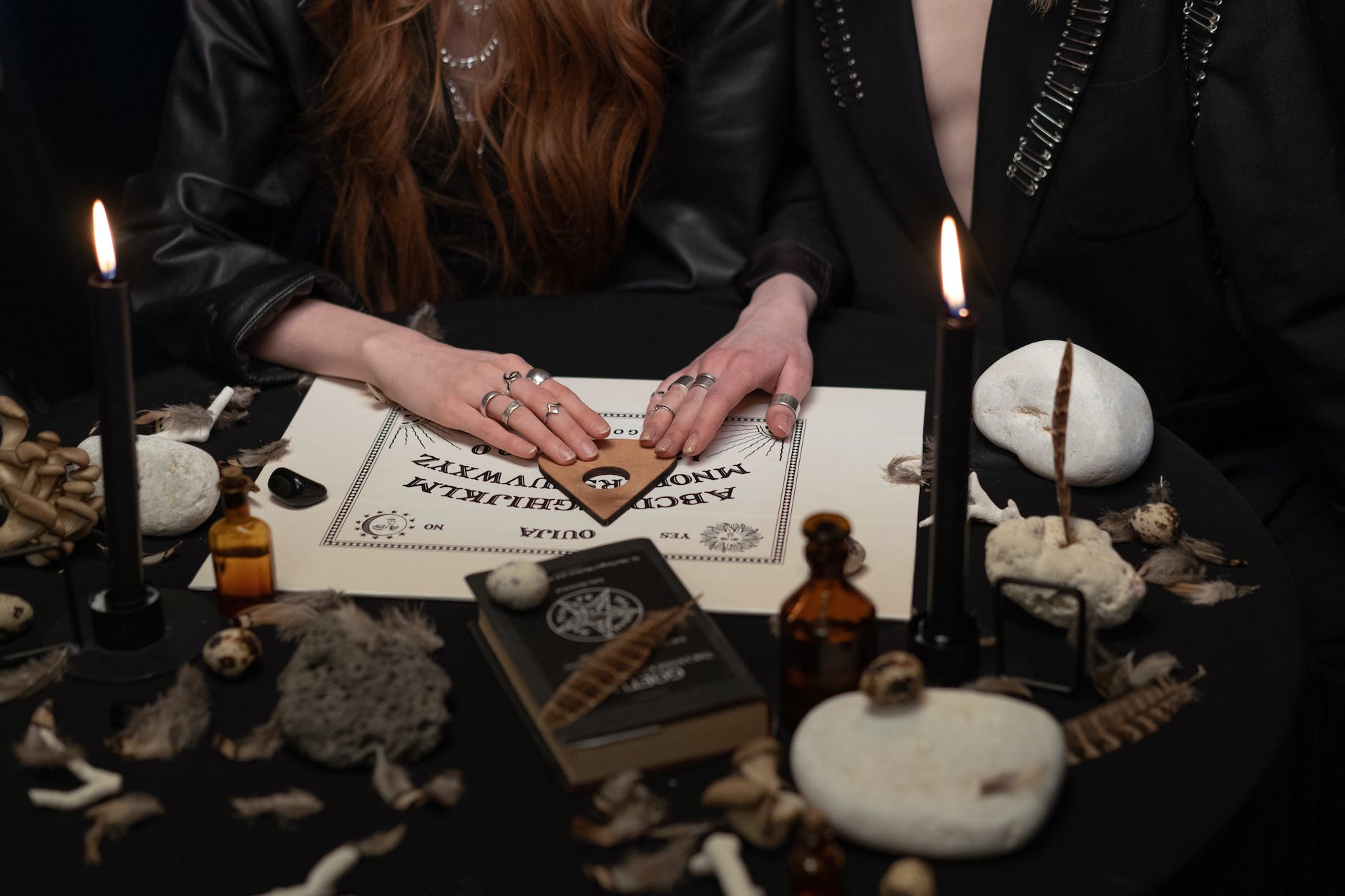 woman in black jacket writing on white paper
